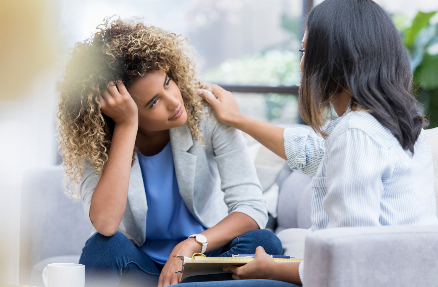 Counselor comforting a woman during therapy session at California Detox & Recovery Center, highlighting compassionate mental health support.