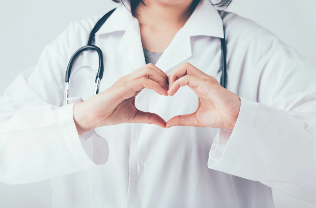Doctor at California Detox & Recovery Center forming heart hands symbol to represent compassionate addiction treatment and supportive care.