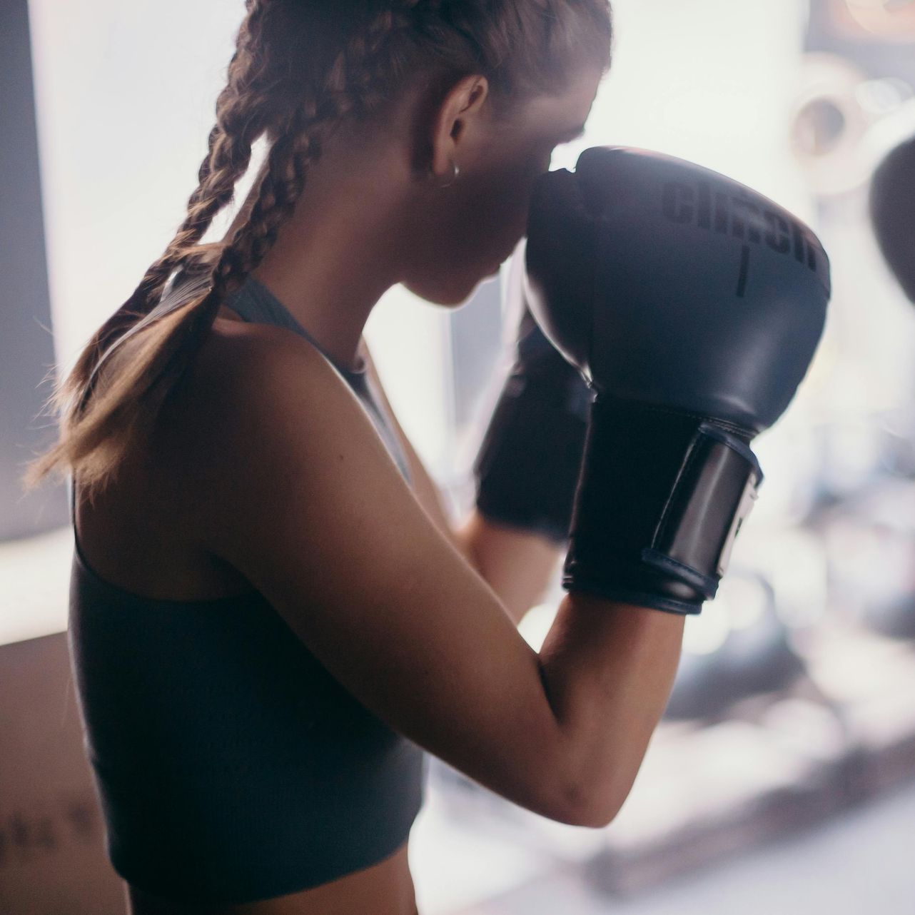 Woman boxing with gloves as part of fitness therapy at California Detox & Recovery Center to support addiction recovery and mental health.