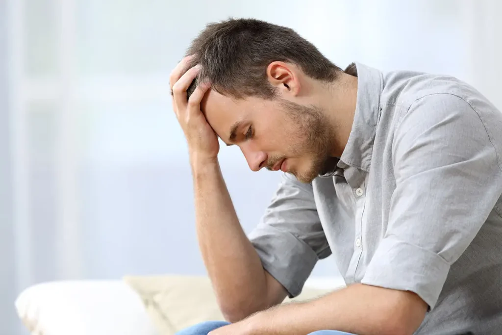 Man struggling with stress and addiction, symbolizing withdrawal symptoms and the effects of addictive medications at California Detox & Recovery Center.