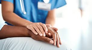Nurse offering compassionate support by holding patient’s hand at a California Detox & Recovery Center focused on addiction treatment and recovery care.