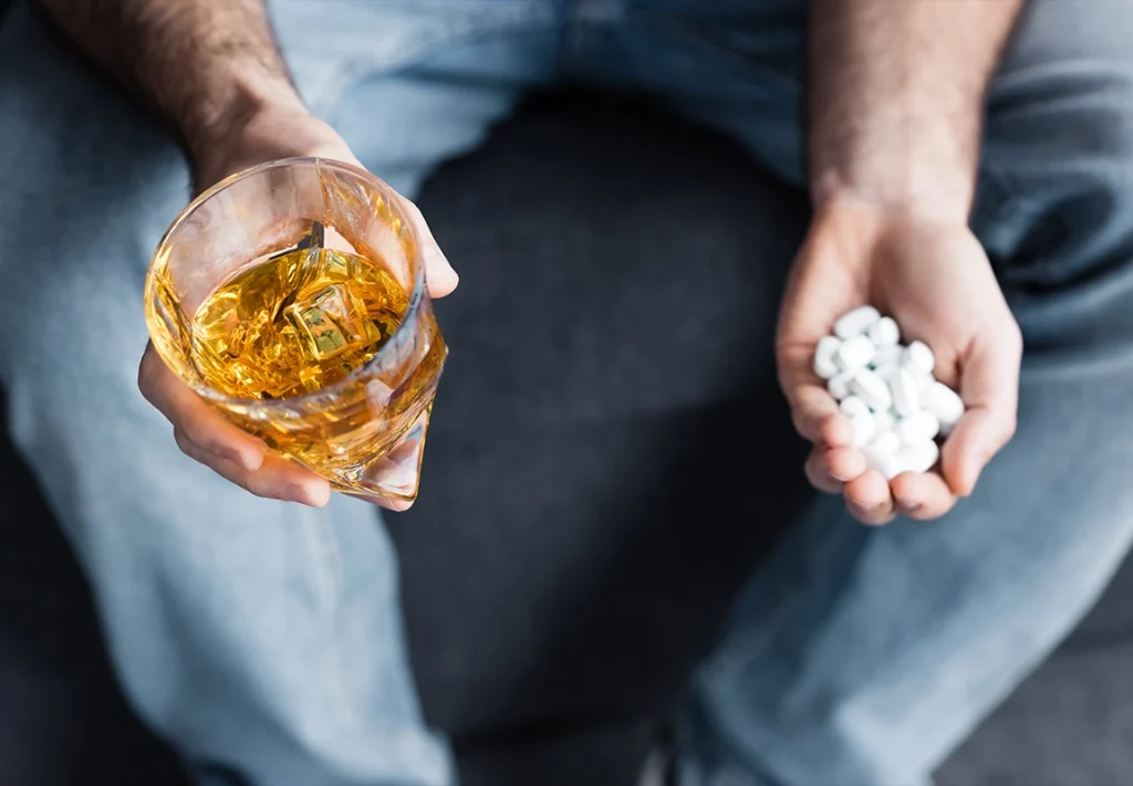 Alcohol and pills symbolizing substance abuse, highlighting the dangers of mixing drugs and alcohol addressed at California Detox & Recovery Center.