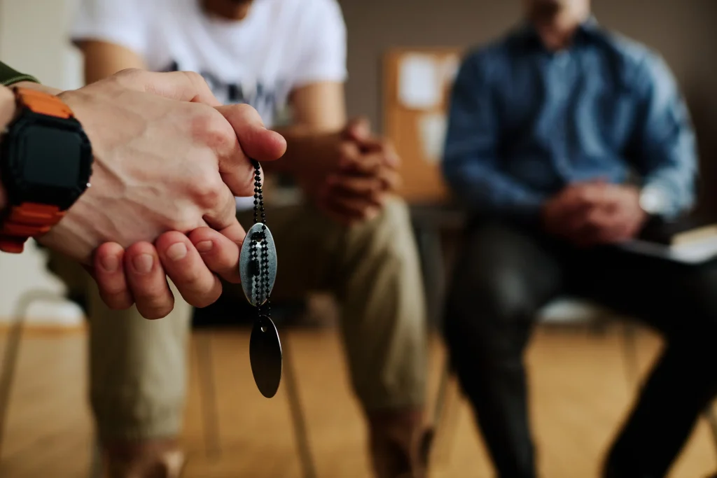 Hands clasped during group therapy, representing emotional support in addiction treatment at California Detox & Recovery Center in Los Angeles.