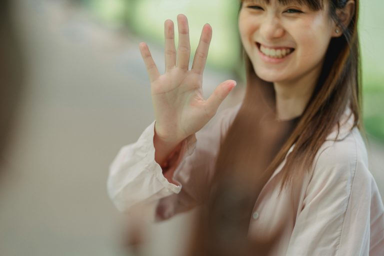 Woman holding up her hand with the background behind her out of focus representing mental health treatment at California Detox & Recovery Center in Los Angeles.