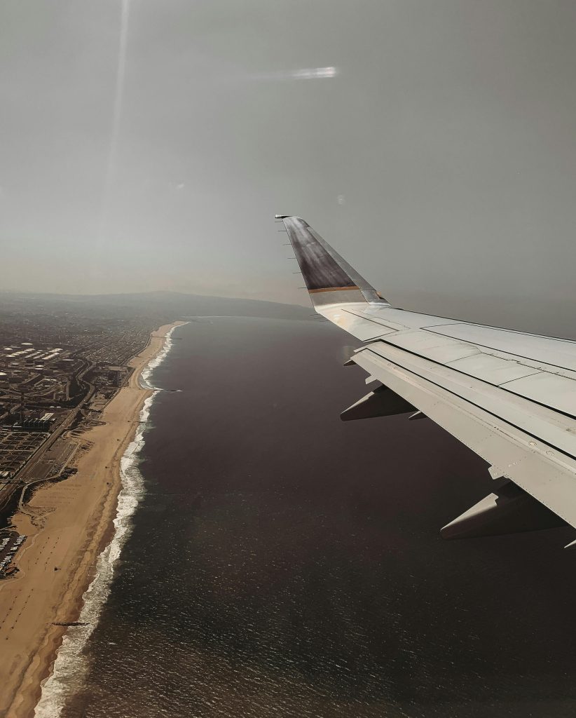 Airplane flying over the California coastline, symbolizing a fresh start through mental health treatment at California Detox & Recovery Center in Los Angeles, California.