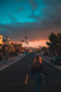 Woman walking down a California street at sunset, representing mental health treatment and healing at California Detox & Recovery Center in Los Angeles, CA