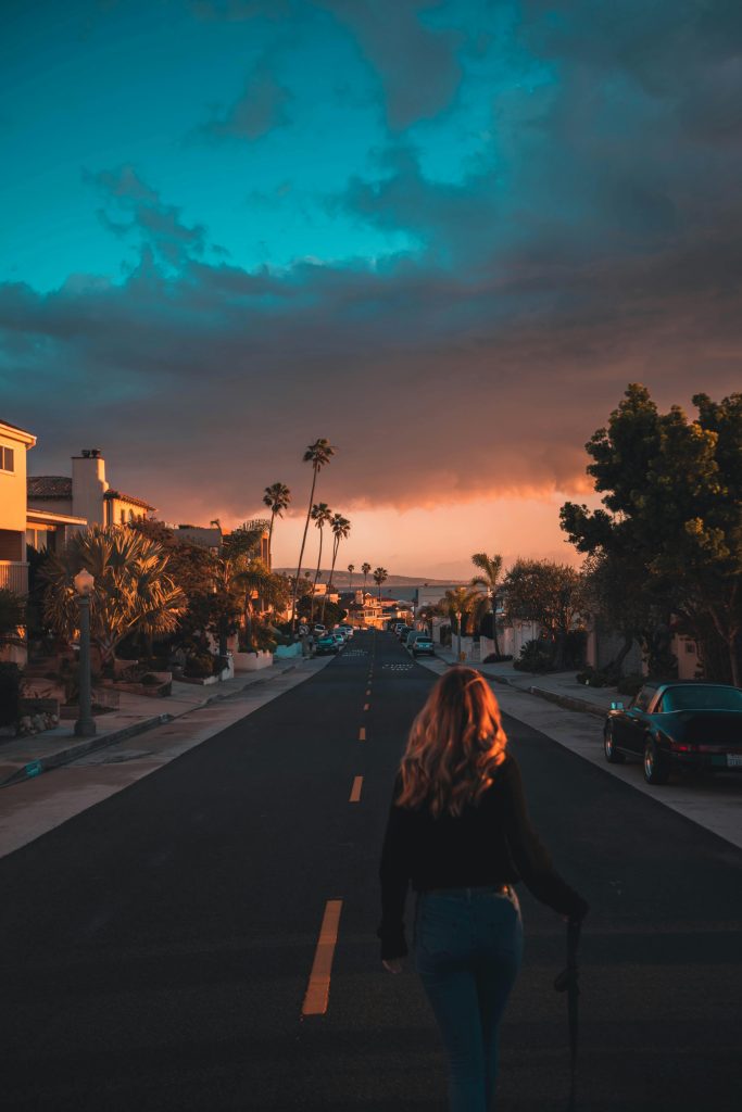 Woman walking down a California street at sunset, representing mental health treatment and healing at California Detox & Recovery Center in Los Angeles, CA