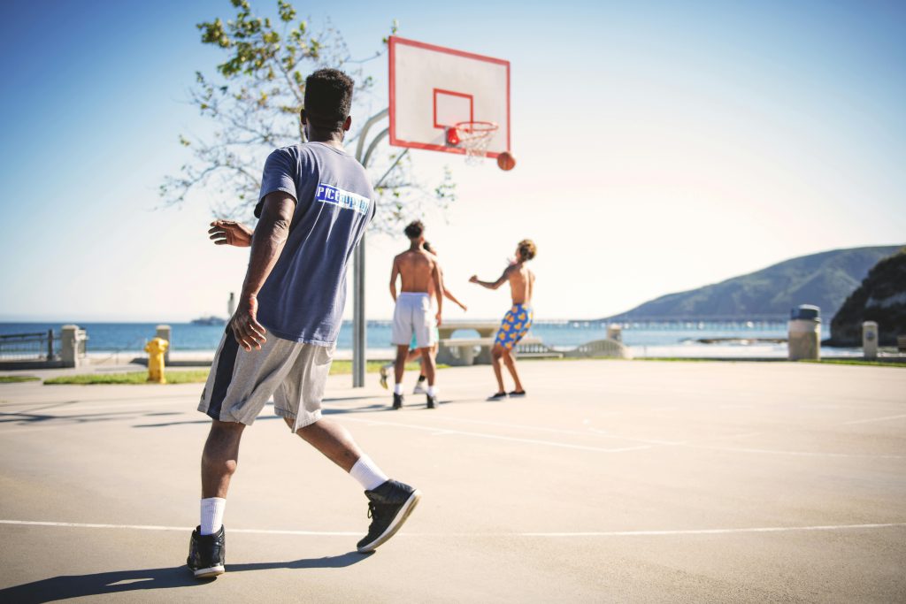 People playing basketball near the beach in Los Angeles, representing healthy routines and community support at a California rehab program in Los Angeles.