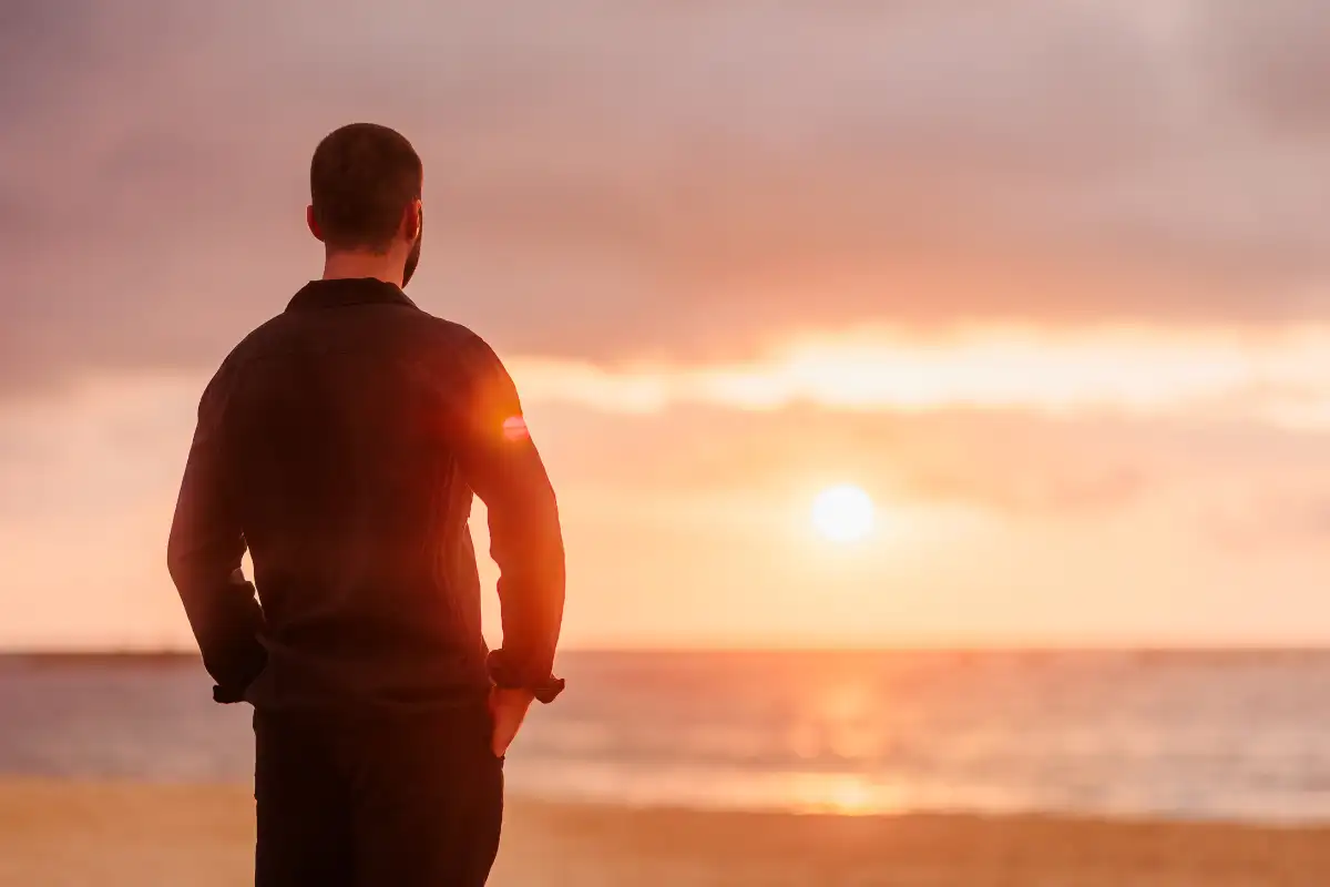Man watching sunset on beach