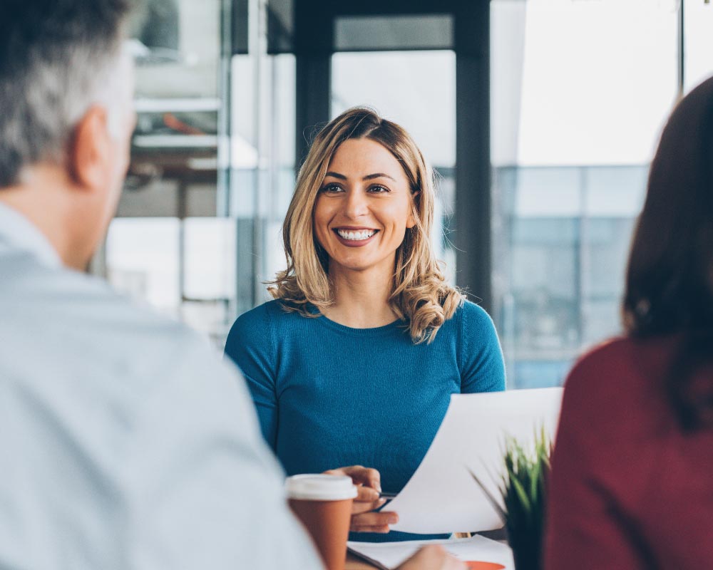 staff discussing insurance policy to a couple