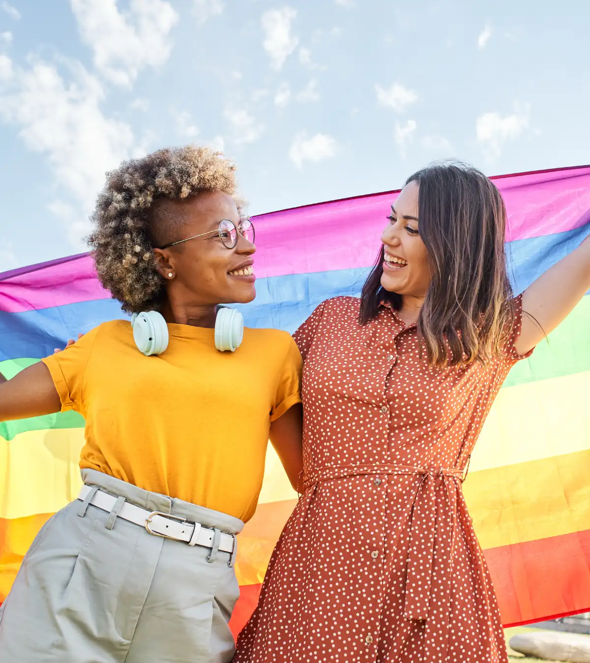 Diverse LGBTQ Couple Holding a Pride Flag