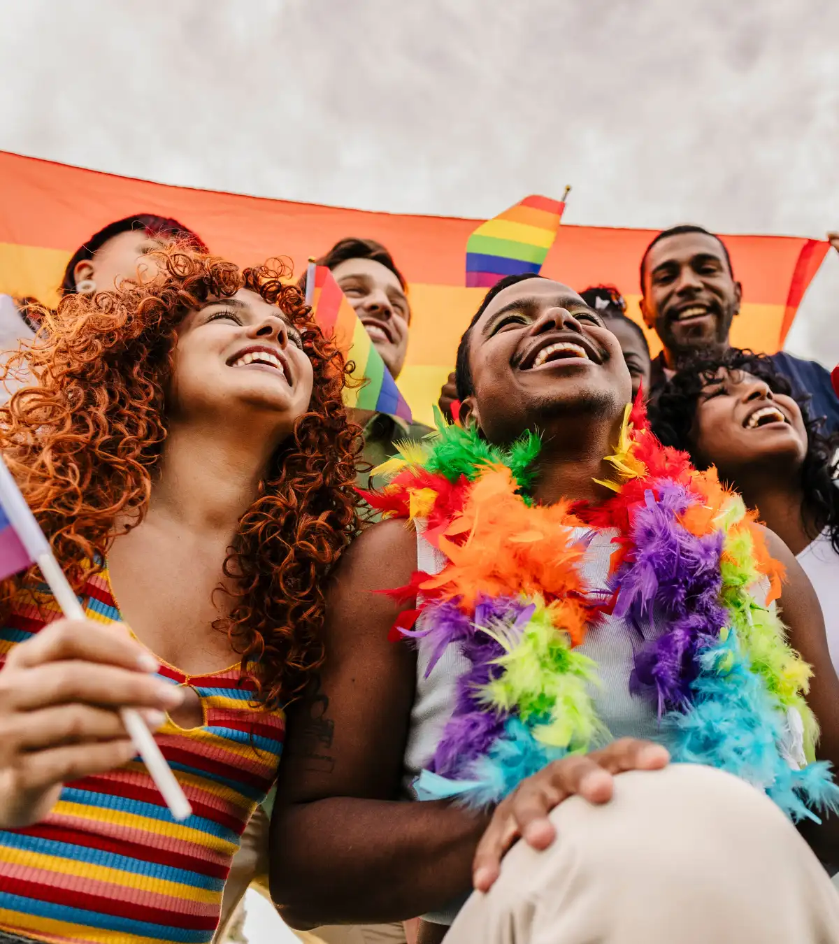 Diverse joyful friends celebrating lgbtq pride parade outdoors