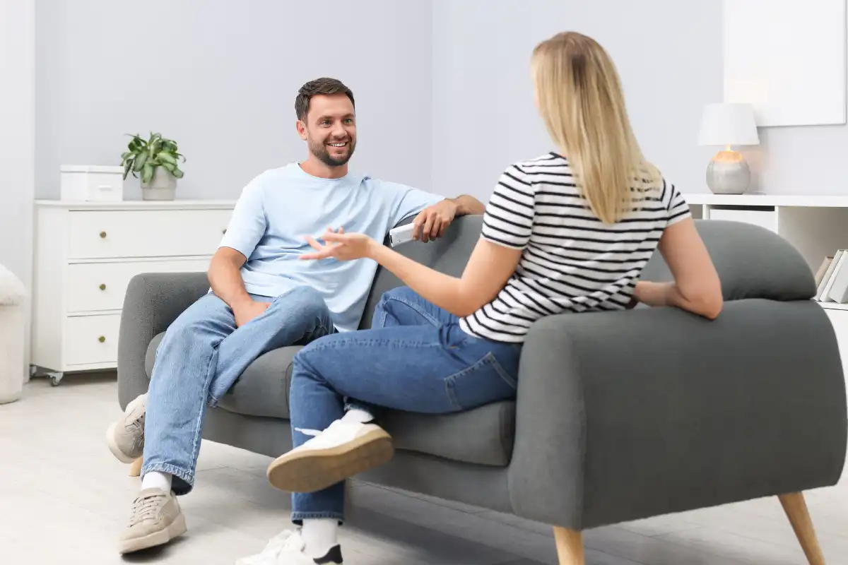 a man and a woman on Sofa at residential setting during one on one therapy
